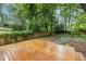 Backyard featuring a wood fence, and a fire pit surrounded by lush greenery at 1424 Van Epps Se Ave, Atlanta, GA 30316