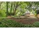 Wide shot of a backyard with a fire pit, small deck, fenced-in area, and partial view of the house at 1424 Van Epps Se Ave, Atlanta, GA 30316
