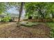 Spacious backyard featuring a small deck, a fire pit surrounded by stones, and wood fencing at 1424 Van Epps Se Ave, Atlanta, GA 30316