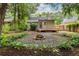 Backyard featuring exterior of home and a fire pit surrounded by lush greenery at 1424 Van Epps Se Ave, Atlanta, GA 30316