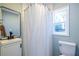 Well-lit bathroom with modern vanity, mirror, and a shower with a curtain at 1424 Van Epps Se Ave, Atlanta, GA 30316