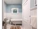 Charming bathroom features a clawfoot tub, a window, wainscoting, and a neutral color palette at 1424 Van Epps Se Ave, Atlanta, GA 30316