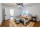 Bedroom features a wrought iron bed frame, hardwood floors, and is well-lit with lots of natural light at 1424 Van Epps Se Ave, Atlanta, GA 30316