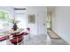 Bright dining area featuring a round table, stylish red chairs, and lovely gray marble flooring at 1424 Van Epps Se Ave, Atlanta, GA 30316