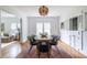 Light and airy dining room with hardwood floors, a stylish table, and a modern light fixture at 1424 Van Epps Se Ave, Atlanta, GA 30316