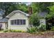 Charming single-story home with a light green exterior, brick foundation, and beautifully landscaped front yard at 1424 Van Epps Se Ave, Atlanta, GA 30316