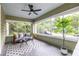 Relaxing screened front porch with stylish furniture, ceiling fan, and views of the surrounding greenery at 1424 Van Epps Se Ave, Atlanta, GA 30316
