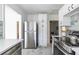 Modern kitchen featuring stainless steel refrigerator, white cabinets, and tile flooring at 1424 Van Epps Se Ave, Atlanta, GA 30316