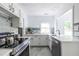 Spacious kitchen featuring stainless steel appliances, white cabinetry, and decorative backsplash at 1424 Van Epps Se Ave, Atlanta, GA 30316