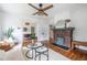 Bright living room features a fireplace, ceiling fan, and hardwood floors at 1424 Van Epps Se Ave, Atlanta, GA 30316