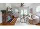 Cozy living room with brick fireplace, neutral color palette, and hardwood floors at 1424 Van Epps Se Ave, Atlanta, GA 30316