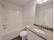 Well lit bathroom features granite countertops, shower and tub at 15 Fontana Ct, Covington, GA 30016