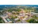 Aerial view of a town featuring mature trees and a variety of commercial and residential buildings at 1678 Lacebark Elm Way Way, Lawrenceville, GA 30045