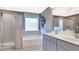 Modern bathroom features double vanity, soaking tub, separate glass-enclosed shower, and a frosted window at 1678 Lacebark Elm Way Way, Lawrenceville, GA 30045