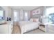 Bedroom decorated with light pink accents, white furniture, and a gray headboard at 1678 Lacebark Elm Way Way, Lawrenceville, GA 30045