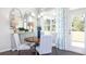 Dining room with hardwood floors, natural light, and a wooden dining table set for four at 1678 Lacebark Elm Way Way, Lawrenceville, GA 30045