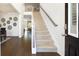 Bright entryway with dark hardwood flooring, stairway to the second floor, and views of other rooms at 1678 Lacebark Elm Way Way, Lawrenceville, GA 30045