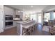 Open concept kitchen features an eat-in island, stainless appliances, and hardwood flooring at 1678 Lacebark Elm Way Way, Lawrenceville, GA 30045