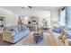 Cozy living room showcases two sofas, decorative pillows, a coffee table and access to the kitchen at 1678 Lacebark Elm Way Way, Lawrenceville, GA 30045