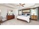 Spacious main bedroom with a tray ceiling, large windows, neutral carpeting and a decorative mirror at 1678 Lacebark Elm Way Way, Lawrenceville, GA 30045