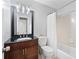 Bathroom with granite countertop, single vanity, framed mirror, and tub shower combo at 403 Defoors Mill Nw Dr, Atlanta, GA 30318