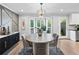 Elegant dining room featuring stylish lighting, large windows, and a view of the backyard at 403 Defoors Mill Nw Dr, Atlanta, GA 30318