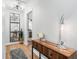 Inviting hallway with hardwood floors, stylish console table, mirror, and decorative lamp at 403 Defoors Mill Nw Dr, Atlanta, GA 30318
