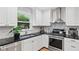 Well-equipped kitchen boasting stainless steel appliances, black countertops, and white cabinets at 403 Defoors Mill Nw Dr, Atlanta, GA 30318