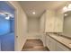 Bathroom featuring granite counters, modern fixtures, tub, and wood-style flooring at 80 Heyman Dr, Covington, GA 30016
