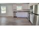 Bright kitchen features stainless steel appliances, granite counters, and white cabinetry at 80 Heyman Dr, Covington, GA 30016