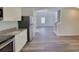 Open-concept kitchen with stainless steel appliances and view to the living room at 80 Heyman Dr, Covington, GA 30016