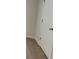 Close up of carpeted upstairs landing with white doors and walls at 80 Heyman Dr, Covington, GA 30016