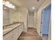 Bright bathroom with granite counters, dual sinks, a walk-in shower, and wood-style flooring at 80 Heyman Dr, Covington, GA 30016