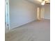 Large carpeted main bedroom with a ceiling fan and ensuite bathroom at 80 Heyman Dr, Covington, GA 30016