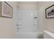 Clean, white bathroom with a tub/shower combo, complemented by neutral paint and tasteful artwork at 1019 Merritt Dr # 102, Villa Rica, GA 30180