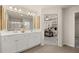 Bathroom with double vanity, white cabinets, modern fixtures and an open view to the main bedroom at 1019 Merritt Dr # 102, Villa Rica, GA 30180