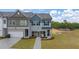 Charming two-story townhome featuring a manicured lawn, attached garage, and craftsman-style details at 1019 Merritt Dr # 102, Villa Rica, GA 30180
