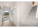 Hallway with a door to outside and featuring beautiful wood floors and a carpeted staircase at 1019 Merritt Dr # 102, Villa Rica, GA 30180