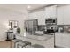 Bright kitchen with white cabinets, granite countertops, stainless steel appliances, and a cozy breakfast bar at 1019 Merritt Dr # 102, Villa Rica, GA 30180