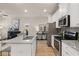 Well-lit kitchen with granite countertops, stainless steel appliances, and an adjacent living space at 1019 Merritt Dr # 102, Villa Rica, GA 30180