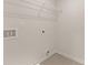 Well-lit laundry room with tile floors, featuring utility hookups and a wire shelf for optimal storage at 1019 Merritt Dr # 102, Villa Rica, GA 30180
