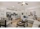 Open-concept living room with white sofa, chair, and wood floors flowing into kitchen with stainless appliances at 1019 Merritt Dr # 102, Villa Rica, GA 30180