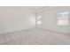 A spacious bedroom showcases neutral walls and plush carpet, complemented by windows with blinds at 141 Bennett Farm Dr, Loganville, GA 30052