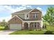 Charming two-story home with brick and siding, a well-manicured lawn, and inviting front porch at 141 Bennett Farm Dr, Loganville, GA 30052