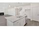 Open kitchen with island, stainless appliances, and view into living room with fireplace at 141 Bennett Farm Dr, Loganville, GA 30052