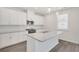 Modern kitchen with white cabinets, granite countertops, stainless steel appliances and a central island at 141 Bennett Farm Dr, Loganville, GA 30052
