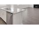 Contemporary kitchen island with granite countertop, stainless steel dishwasher, and hardwood flooring at 141 Bennett Farm Dr, Loganville, GA 30052