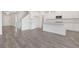 Spacious open-concept living area and kitchen with modern hard wood flooring at 141 Bennett Farm Dr, Loganville, GA 30052