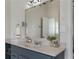 Charming bathroom boasts a gray vanity with a mirror and modern lighting at 1491 Black Hickory Pl, Norcross, GA 30093