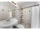 Bathroom showcasing a shower with a white shower curtain and a single sink with a neutral countertop at 1491 Black Hickory Pl, Norcross, GA 30093